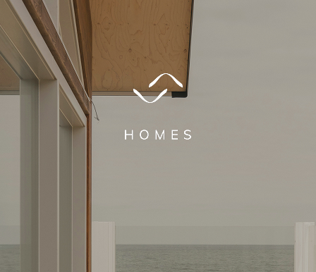 Triada Homes Logo on a modern clean house and sky background
